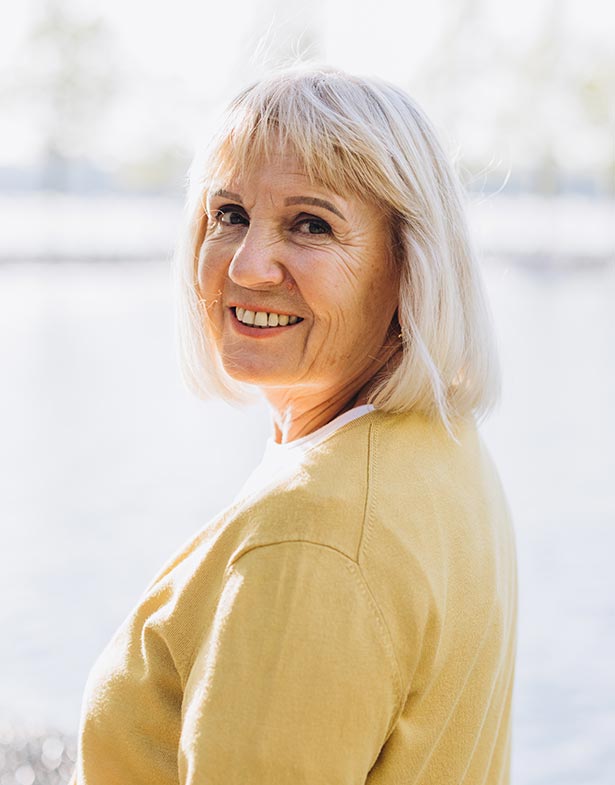 Senior woman turning around and smiling at the camera